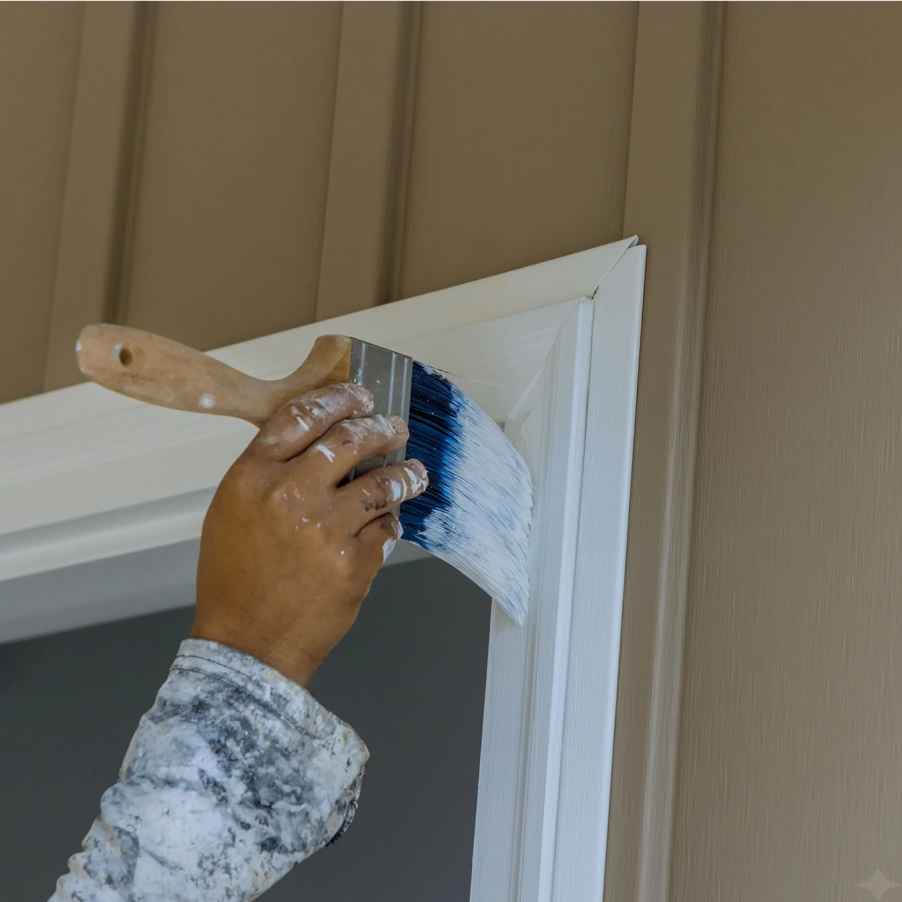 Painter cutting a clean line on exterior door trim with a brush